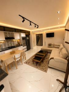 a living room with a couch and a table at Resedece Ihssene in Kolea