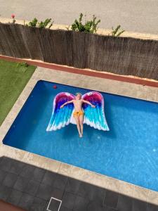 a man with wings on a swimming pool at Skydiversnestdotcom in Bollullos de la Mitación