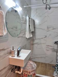 a bathroom with a sink and a mirror at Studios Μιχαλαρεα in Kyparissia