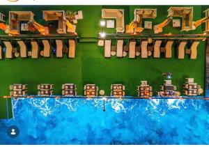 a room with a swimming pool and a green wall at White House Apart in Kaş