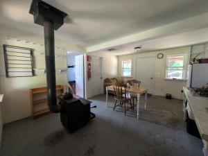 a kitchen and dining room with a stove in a room at Nezinscot Pines in Hartford