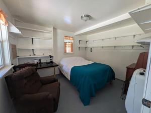 a bedroom with a bed and a desk and a couch at Nezinscot Pines in Hartford
