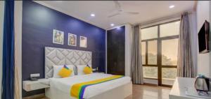 a bedroom with a large bed with a blue wall at The corbett story in Rāmnagar