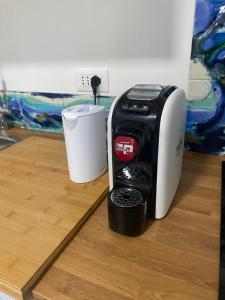 a coffee maker and a cup on a counter at Bblueb&b in Rimini