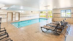 a pool with chairs and a swimming pool at Holiday Inn Express & Suites Glenpool by IHG in Glenpool
