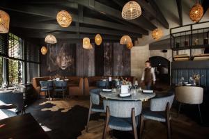 a dining room with tables and chairs and lights at Paping Hotel & Spa - Rest Vonck by Flow in Ommen