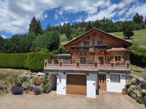 a house with a balcony on top of it at Ferienhaus Kleinlercher in Iselsberg