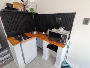 a small kitchen with a microwave on a wooden counter at 284 on circular 3 in Sunridge Park