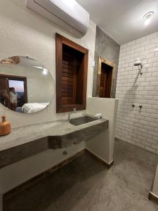 a bathroom with a sink and a mirror at Refúgio prea in Cruz +27 photos