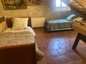 a small room with two beds and a desk at Gîte de la Plonde in Labessière-Candeil