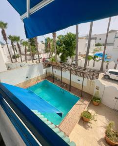 a swimming pool on the roof of a building at Villa Omi Zina in Nabeul