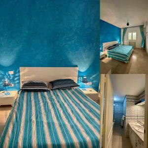 a bedroom with a bed with a blue wall at Villa Omi Zina in Nabeul