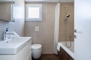 a bathroom with a sink and a toilet and a shower at Luxury 2BR Limassol Marina Views in Limassol +8 photos