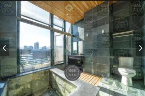 a bathroom with a toilet and a large window at 元本山明水秀行館 in Jiaoxi +126 photos