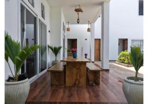 a living room with a wooden table and potted plants at Verdana House in Kiwengwa