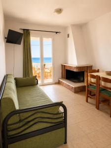a room with a bed and a table and a window at Marialena hotel in Archangelos