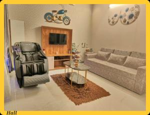 a living room with a couch and a table at UDUPI HOMESTAY CHALET LA BONNE Vie in Udupi