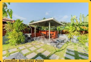 a patio with a table and a pavilion barbecue point at UDUPI HOMESTAY CHALET LA BONNE Vie in Udupi