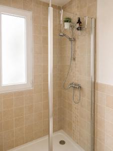 a shower with a glass door in a bathroom at Slimmo Studio in Château-Chinon
