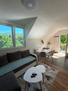 a living room with a couch and a table at Jasmin in Jošanička Banja