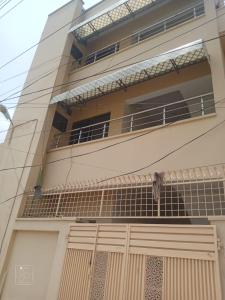 an external view of a building with a balcony at Crown Valley Guest House in Lahore