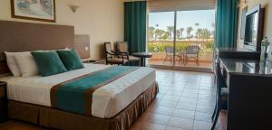 a hotel room with a bed and a balcony at Hurghada Long Beach Resort in Hurghada +197 photos