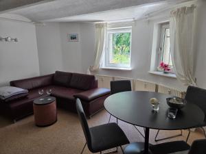 a living room with a couch and a table at FeWo Bismarck in Goslar