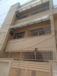 a house with a fence in front of it at Crown Valley Guest House in Lahore +11 photos