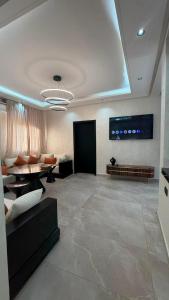 a living room with a couch and a table at Villa with pool, ping pong table, trampoline in Mellah Bakka