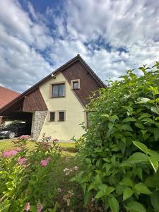 a house with a car parked in front of it at Chalet Parížovce with swimming pool and mountain views in Liptovský Trnovec