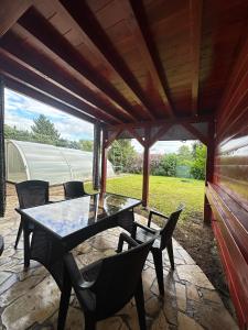 a patio with a table and chairs on it at Chalet Parížovce with swimming pool and mountain views in Liptovský Trnovec