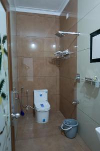 a bathroom with a toilet and a shower at Nirmalyam Homestay in Kuttippuram +64 photos