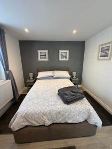 a bedroom with a bed with a black bag on it at Home Away From Home in Blean