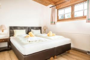 a bedroom with two beds and a window at Ferienhof Millinghof in Leogang