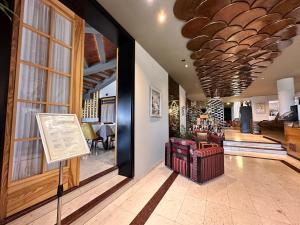 a lobby with a room with a table and chairs at Chateau Linza Resort in Tirana