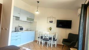 a kitchen with a table and a small kitchen with a table and chairs at Casa Giulia Olbiamare in Olbia