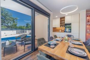 a dining room and kitchen with a table and chairs at Villa LeSt in Gabonjin