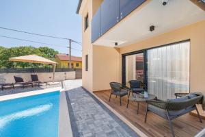 a villa with a swimming pool and a house at Villa LeSt in Gabonjin