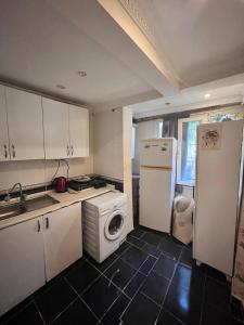 a kitchen with a white refrigerator and a washing machine at Ramonun Yeri in Istanbul +66 photos