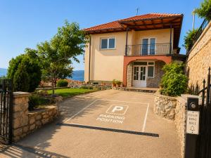 a house with a parking restriction sign in front of it at Apartments Sunset Jovanoski in Ohrid