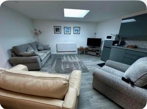 a living room with two couches and a couch at Home Away From Home in Blean
