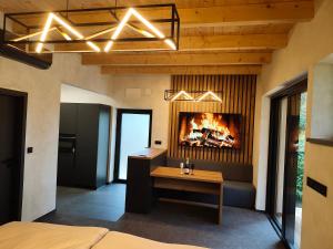 a bedroom with a fireplace in the wall with a table at Hotel Kras in Jedovnice