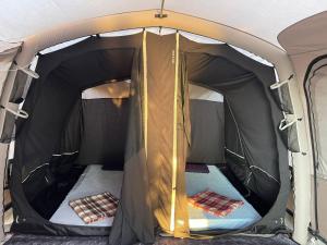 an inside of a tent with the door open at Blue Camping in Borsh, Vlorë in Borsh