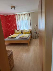 a bedroom with a bed with yellow pillows at Haus Brenntara 1 in Rangersdorf
