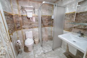 a bathroom with a shower and a toilet and a sink at Şehrizade Konakları in Amasya +63 photos