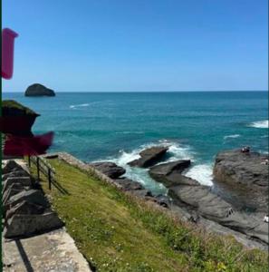 a view of the ocean with rocks and water at Strand Retreat in Tintagel +3 photos