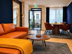 a living room with a couch and a table at Luxury Apartment Königsallee Old Town Rhine Promenade Messe in Düsseldorf