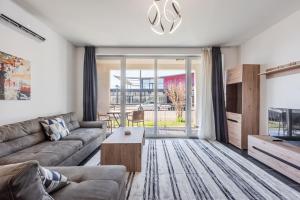 a living room with a couch and a tv at Coastal Haven Talea by PikHost in Tale