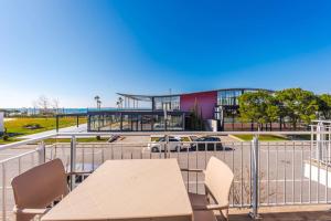a table and chairs in front of a building at Coastal Haven Talea by PikHost in Tale