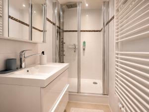 a white bathroom with a sink and a shower at Luxury Apartment Königsallee Old Town Rhine Promenade Messe in Düsseldorf